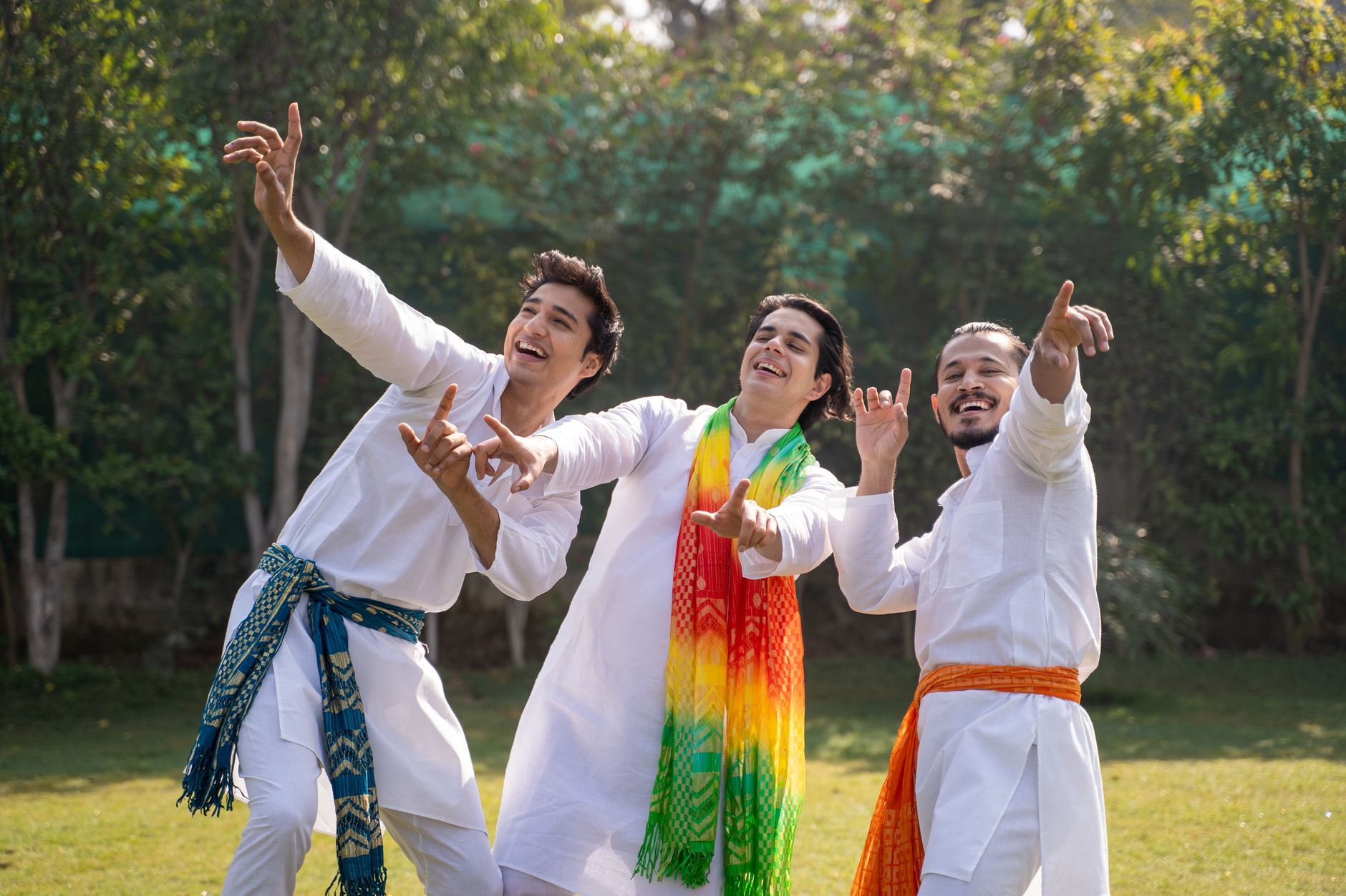 a group of men in white long sleeves smiling